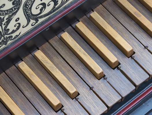 keyboard of old harpsichord with brown wooden keys