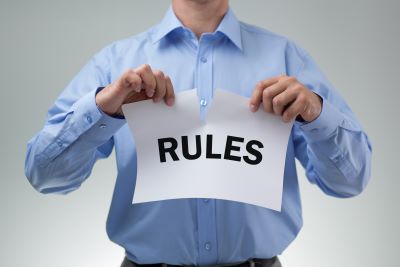 A man is tearing up a page of rules